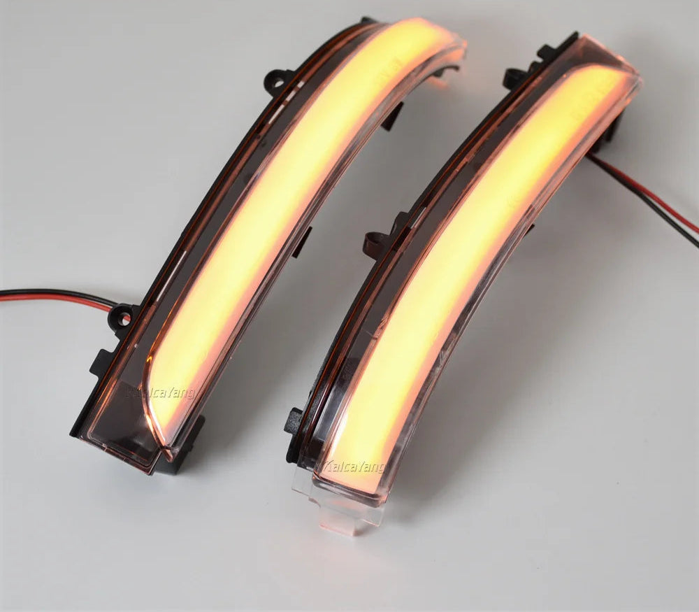 Two curved LED lights with visible wiring on a gray background